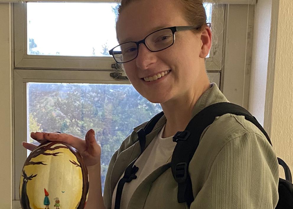 Student with decorated pumpkin