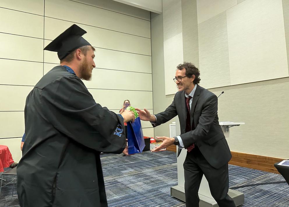 Christopher Dinneen, B.A. receives gradution gift from Prof. & DUS Fiorentino